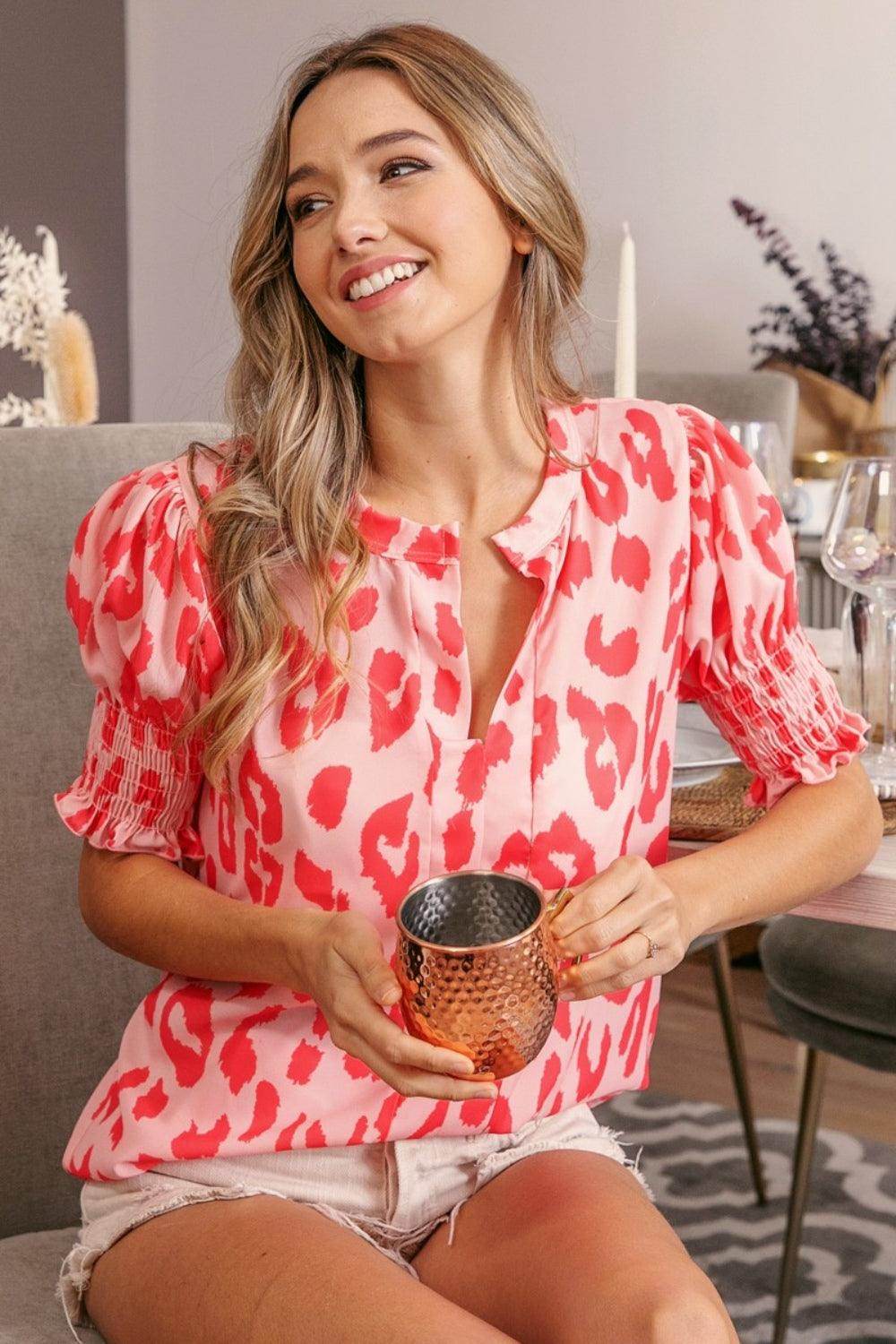 Leopard print BiBi smocked short sleeve blouse from Trendsi, featuring a trendy, fitted design with a stylish neckline.