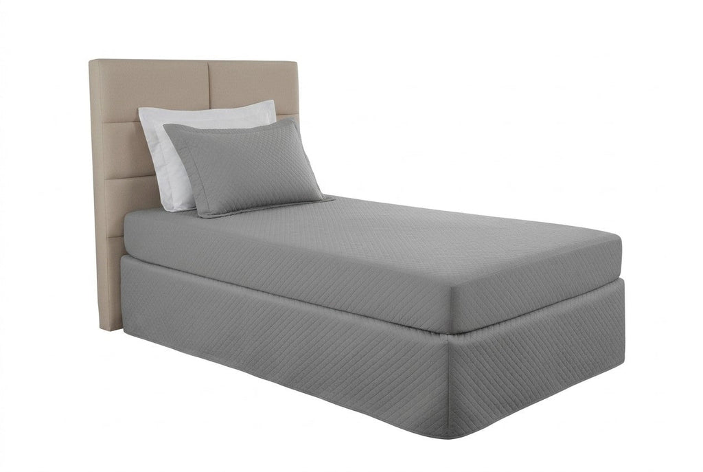 Gray Maison Charlo waterproof quilted mattress protector for single beds, designed to protect and add comfort to bedding.