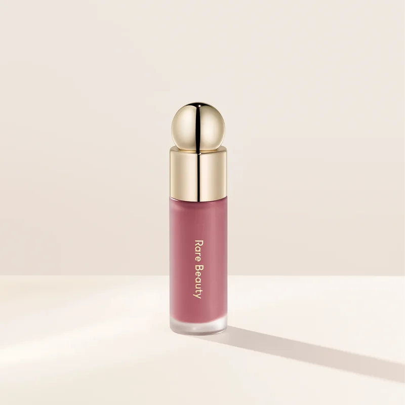 Veltora Rare Beauty Soft Pinch Liquid Blush in a silky, long-lasting pink formula on a makeup face.