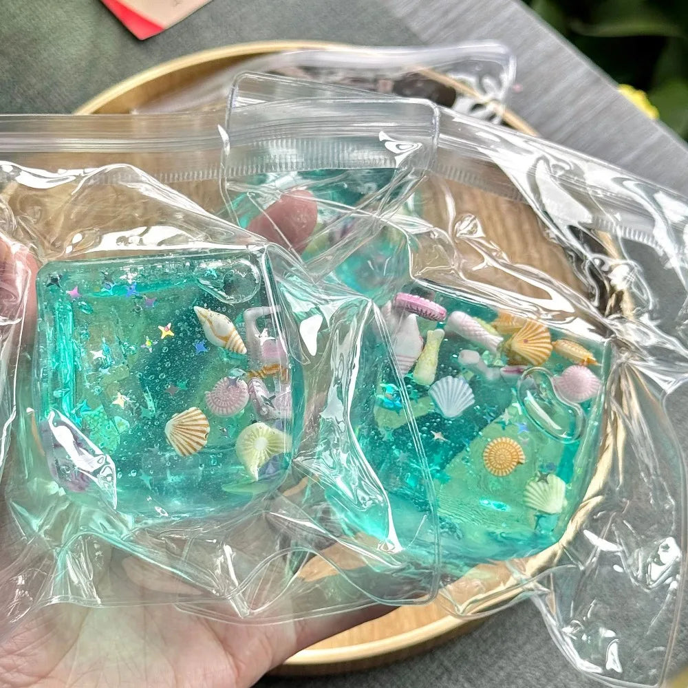 Veltora Taba Squishy Stress Ball cube featuring ocean design, slow rise fidget toy for kids and adults to squeeze and relax.