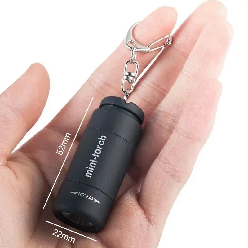 Veltora waterproof pocket keychain flashlight with LED light, USB rechargeable, compact for outdoor hiking and camping activities.