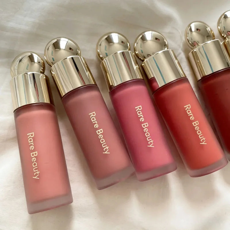 Veltora Rare Beauty Soft Pinch Liquid Blush in a sleek bottle, showcasing the silky smooth, long-lasting makeup with a natural pink hue.
