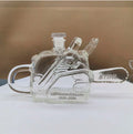 Veltora chainsaw-shaped glass whiskey decanter, 100th anniversary commemorative liquor bottle, industrial-style spirits carafe.