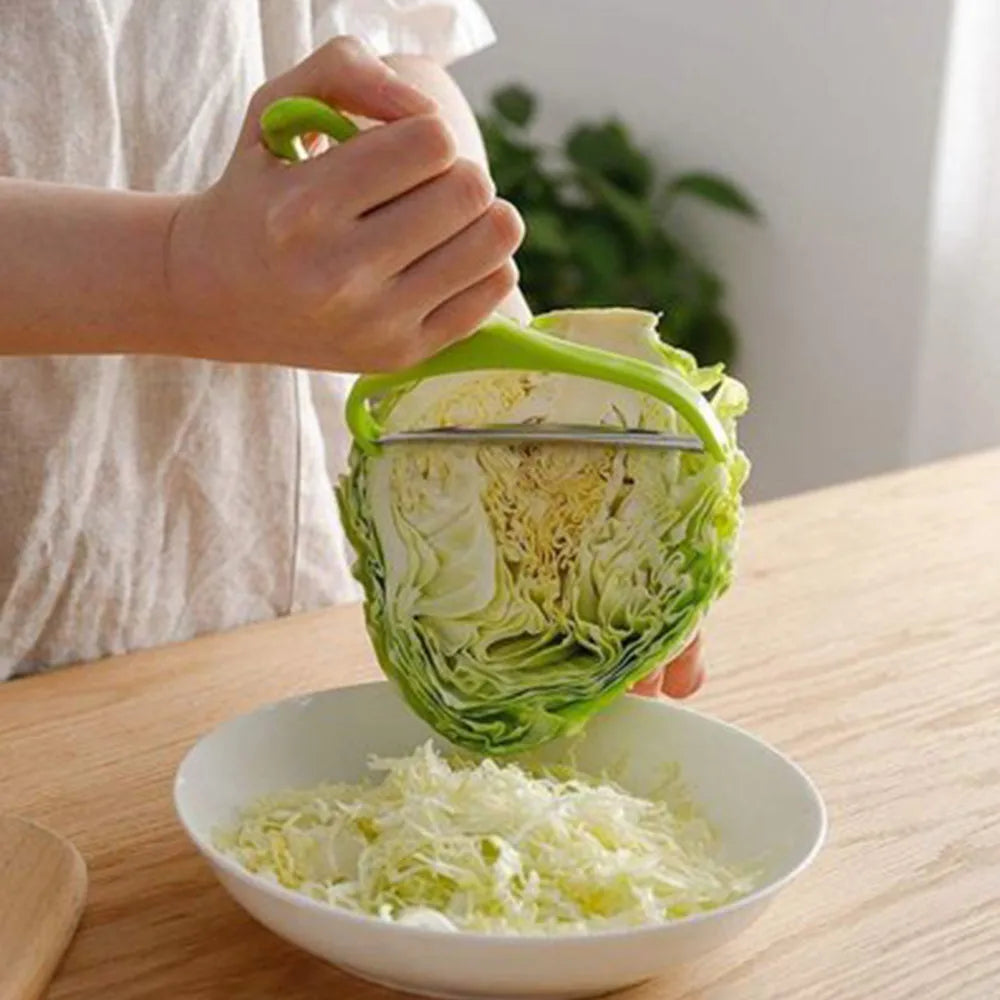 Veltora cabbage slicer and vegetable cutter with stainless steel grater for salads, potatoes, carrots, and cucumbers in a home kitchen setting.