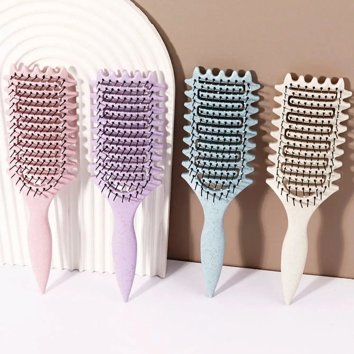 Veltora curling styling brush with hollow massage comb and nylon mane, featuring an ABS plastic handle with a comfortable grip for real hair wigs.