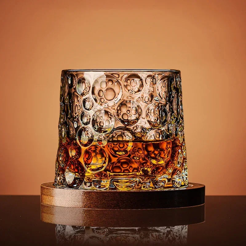 Veltora crystal whiskey tumbler glass with rotating base, ideal for wine, brandy, and drinkware at bar or home settings.