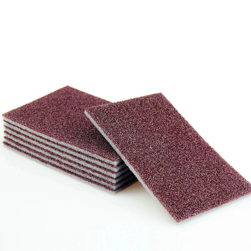 Veltora heavy-duty melamine sponge for cleaning motorcycle parts and kitchen surfaces, showing a close-up of the cleaning tool.