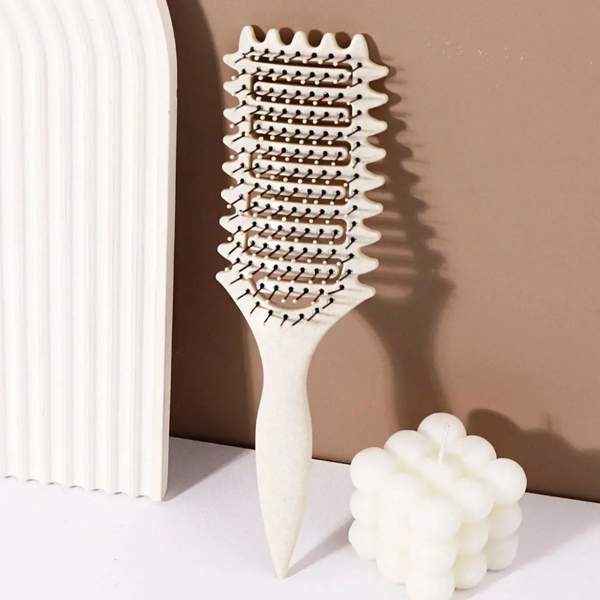 Veltora curling styling brush with hollow massage comb, nylon mane, and ABS plastic handle for comfortable grip on real hair wigs.