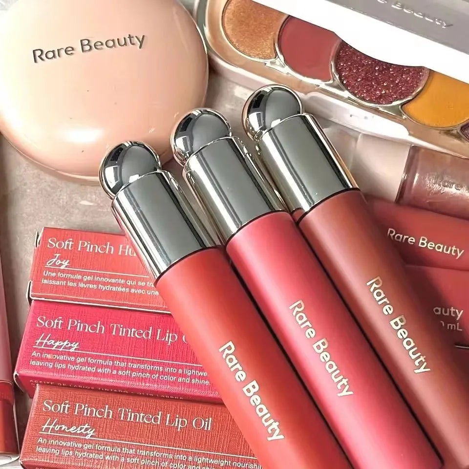 Veltora Rare Beauty Soft Pinch Liquid Blush in a silky, long-lasting pink formula, showcased on a model's cheek for a natural glow.