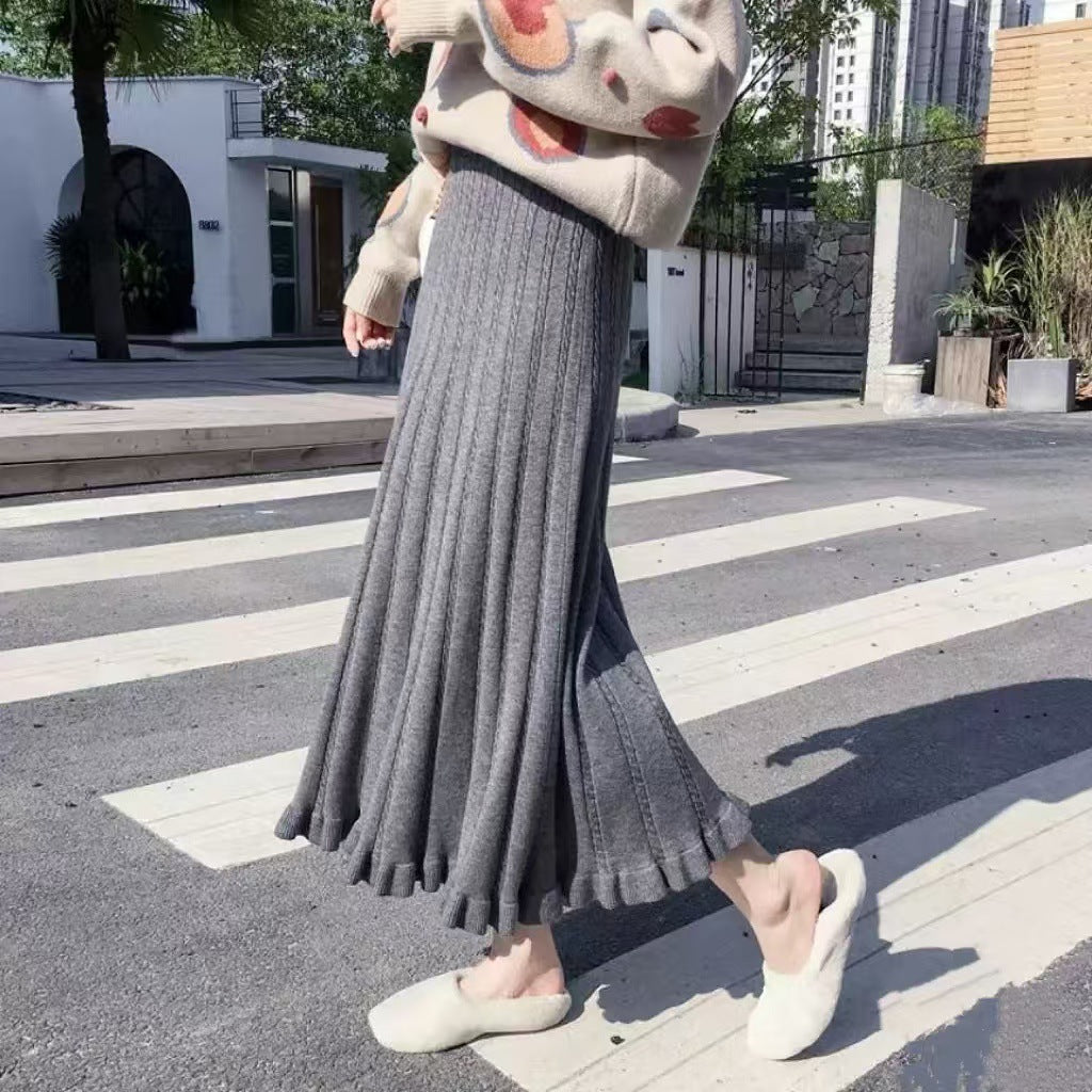 Gray women's knitted mid-length ruffled skirt for fall and winter, showcasing soft fabric and stylish ruffle details.
