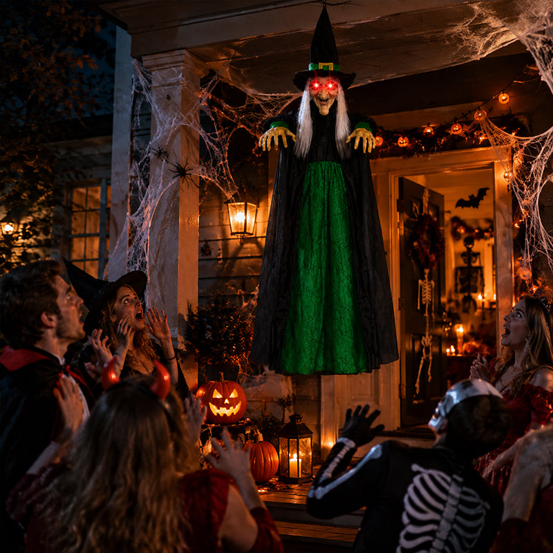 Life size purple talking witch decoration with glowing eyes, animatronic features, and screaming expression for Halloween outdoor spooky decor