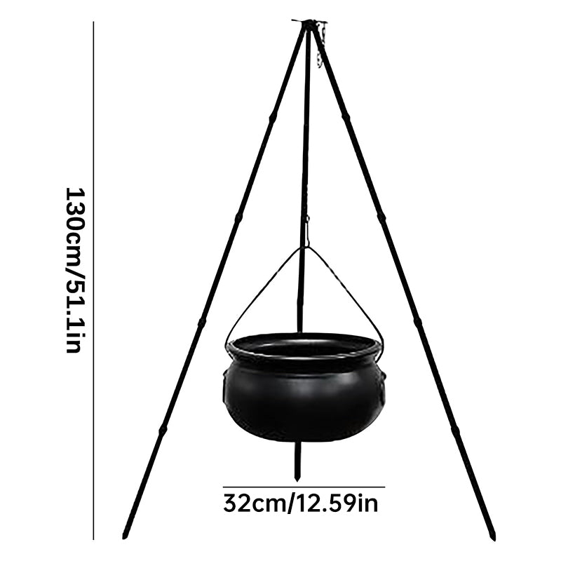 Black Halloween witches' cauldron with skeletons on tripod, outdoor horror house decoration, spooky prop for Halloween display