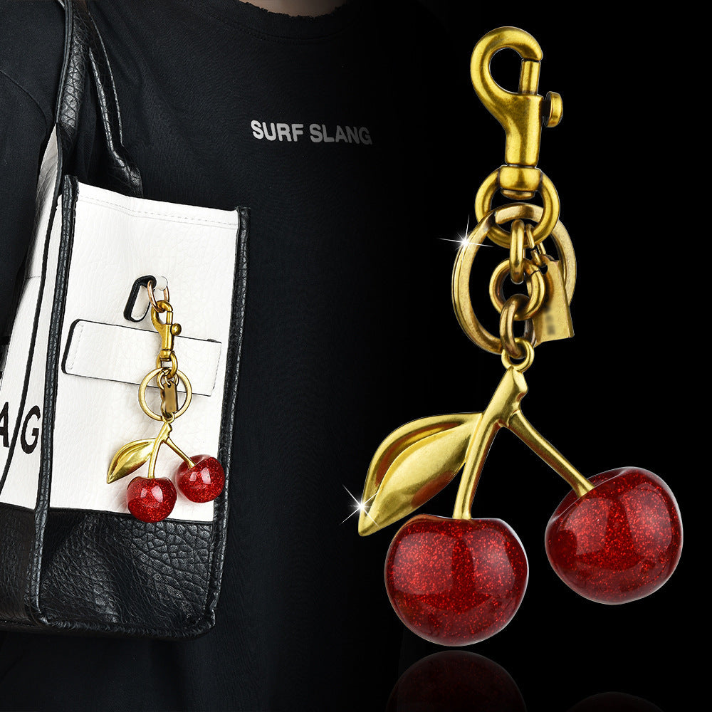 Red cherry-shaped keychain bag pendant by eprolo featuring an exquisite, classic cherry charm accessory.
