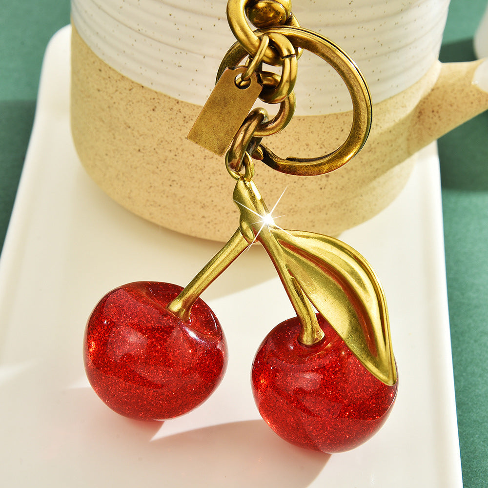 Red cherry keychain bag pendant accessory by eprolo, featuring an exquisite cherry-shaped charm with a classic design.