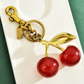 Red cherry-shaped keychain bag pendant by eprolo, featuring an exquisite cherry charm accessory on a classic design.