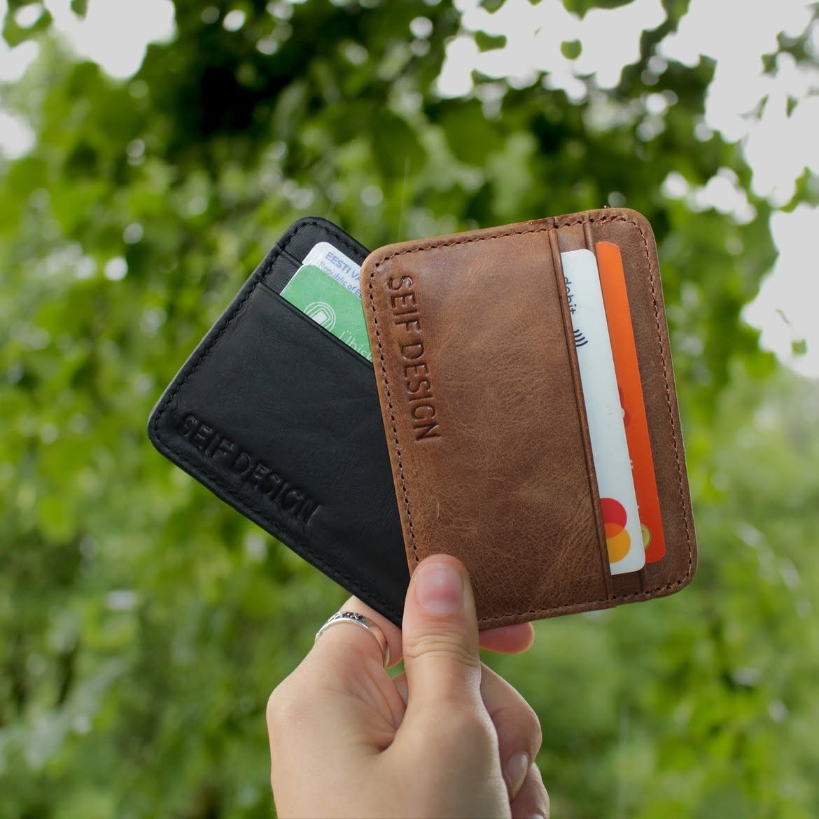 Black handmade leather card holder by Seif Design, featuring a sleek compact design with multiple card slots.