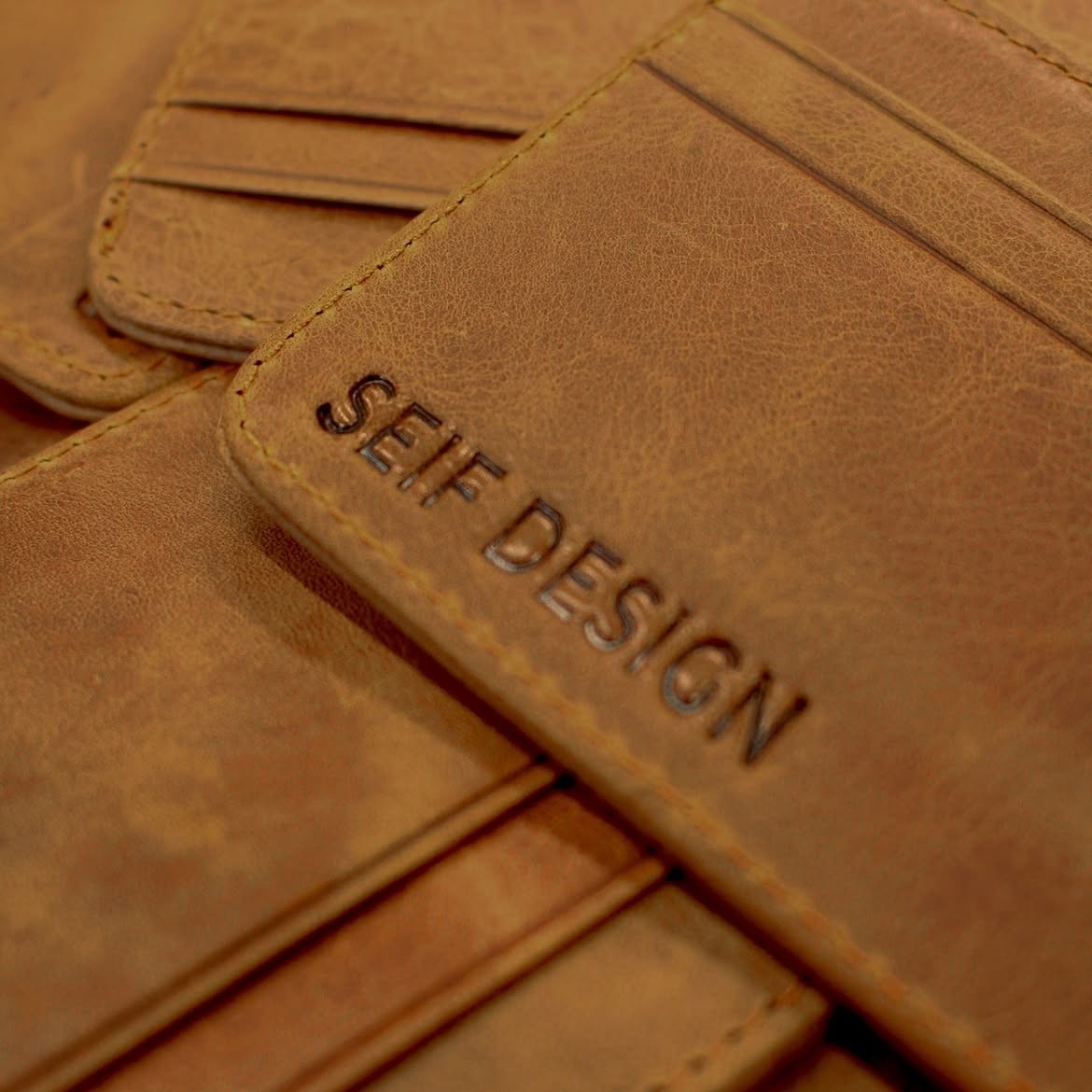 Brown handmade leather card holder by Seif Design with multiple card slots and sleek design.