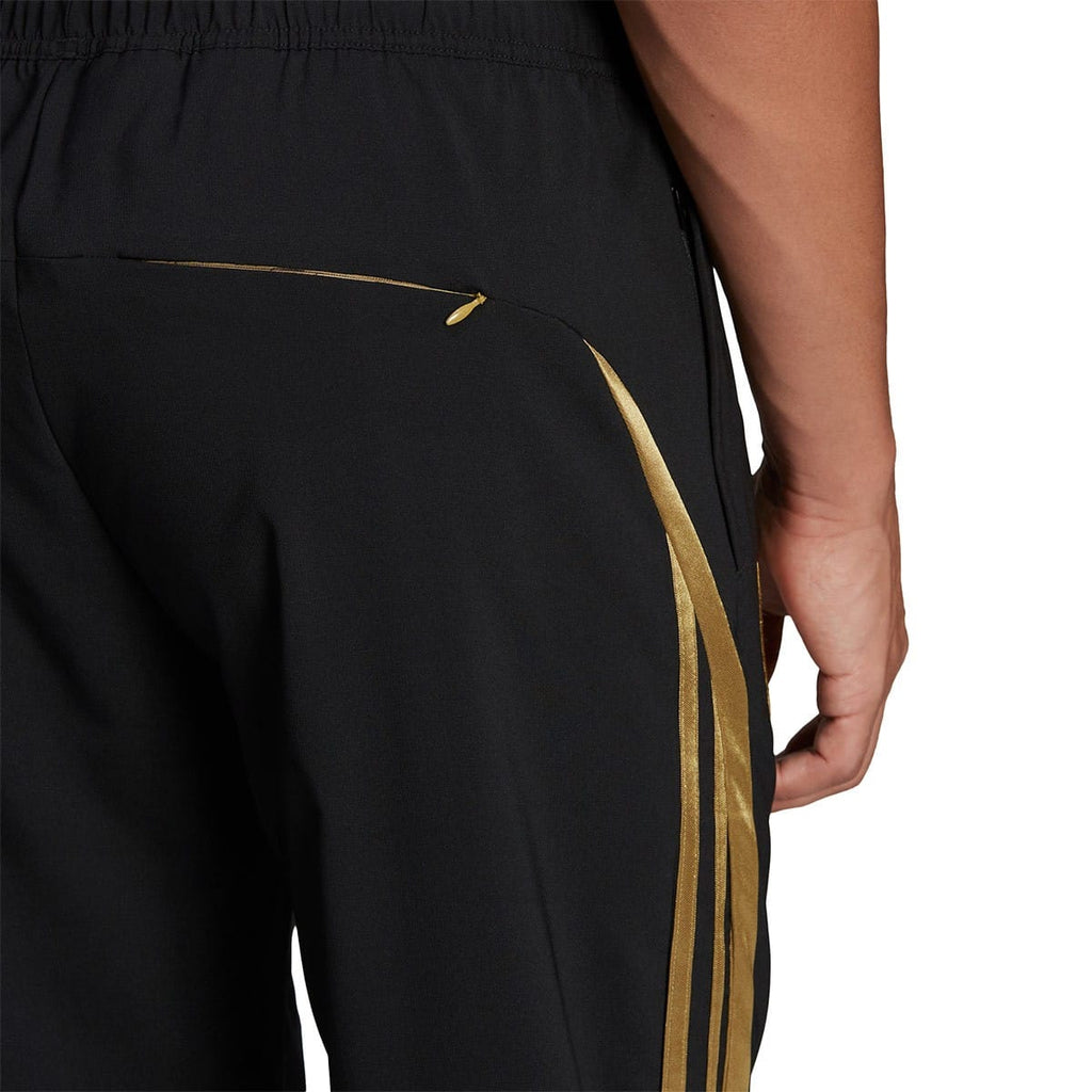 Arsenal retro woven presentation tracksuit for men by Adidas, featuring classic design and detailed fabric close-up.