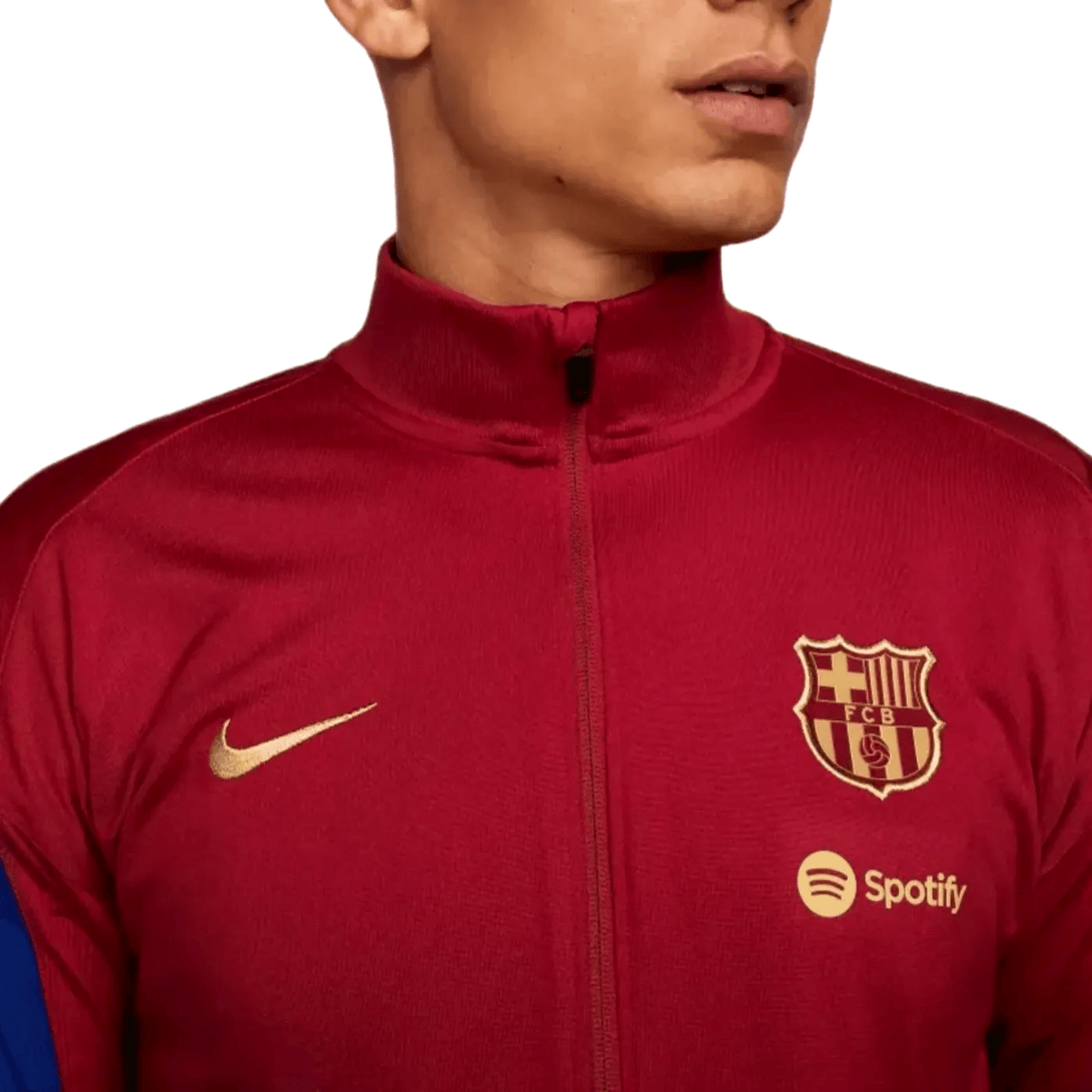 Red and blue FC Barcelona training tracksuit for 2024 by Nike, shown on a person wearing the presentation-style soccer tracksuit.